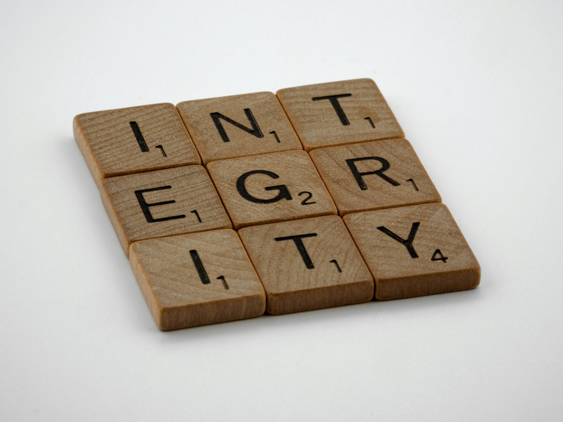 a scrabbled wooden block with the words integr city on it