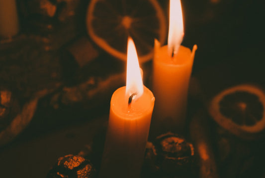 three lit candles sitting on top of a table
