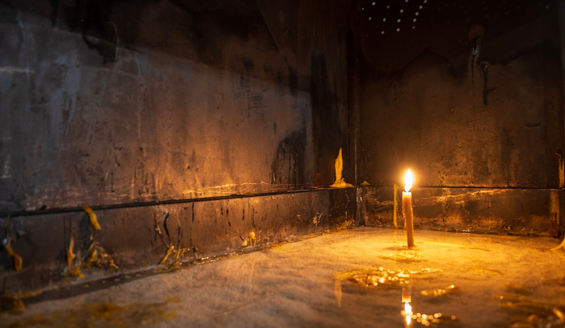 A candle is lit in a dimly lit room