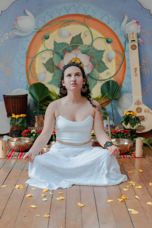 Woman meditating in a room with musical instruments.