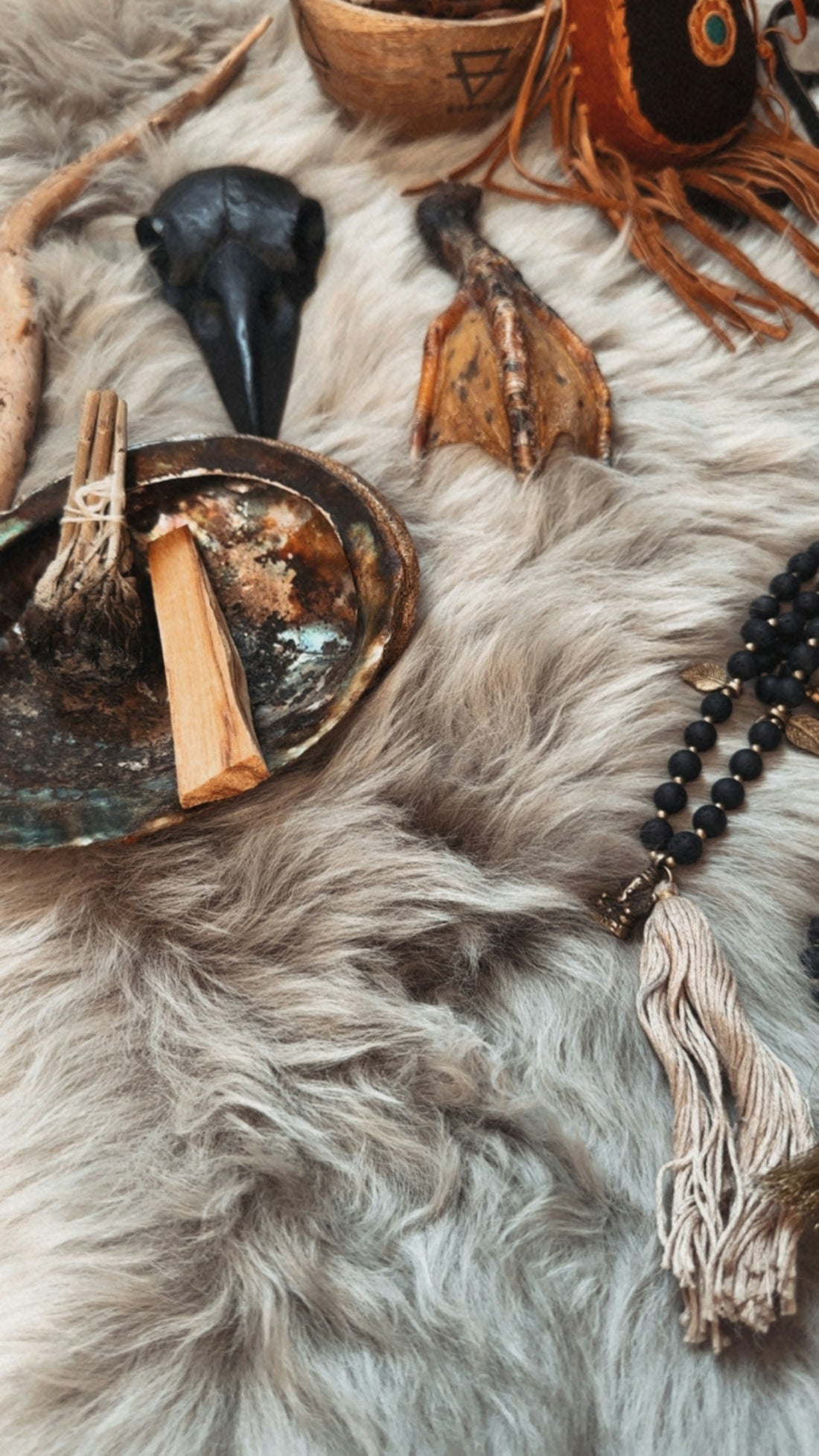 Various spiritual objects arranged on a furry surface.